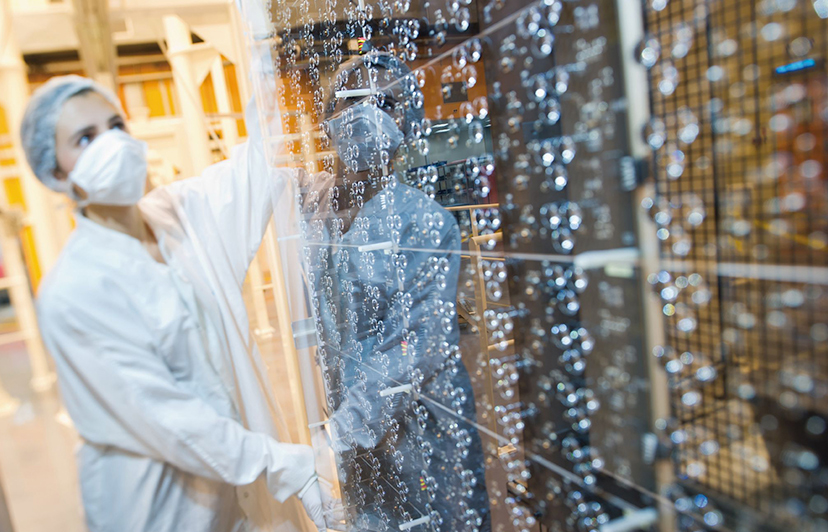 scientist moving piece of space shuttle in lab