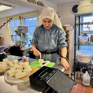woman packaging cheese wedges
